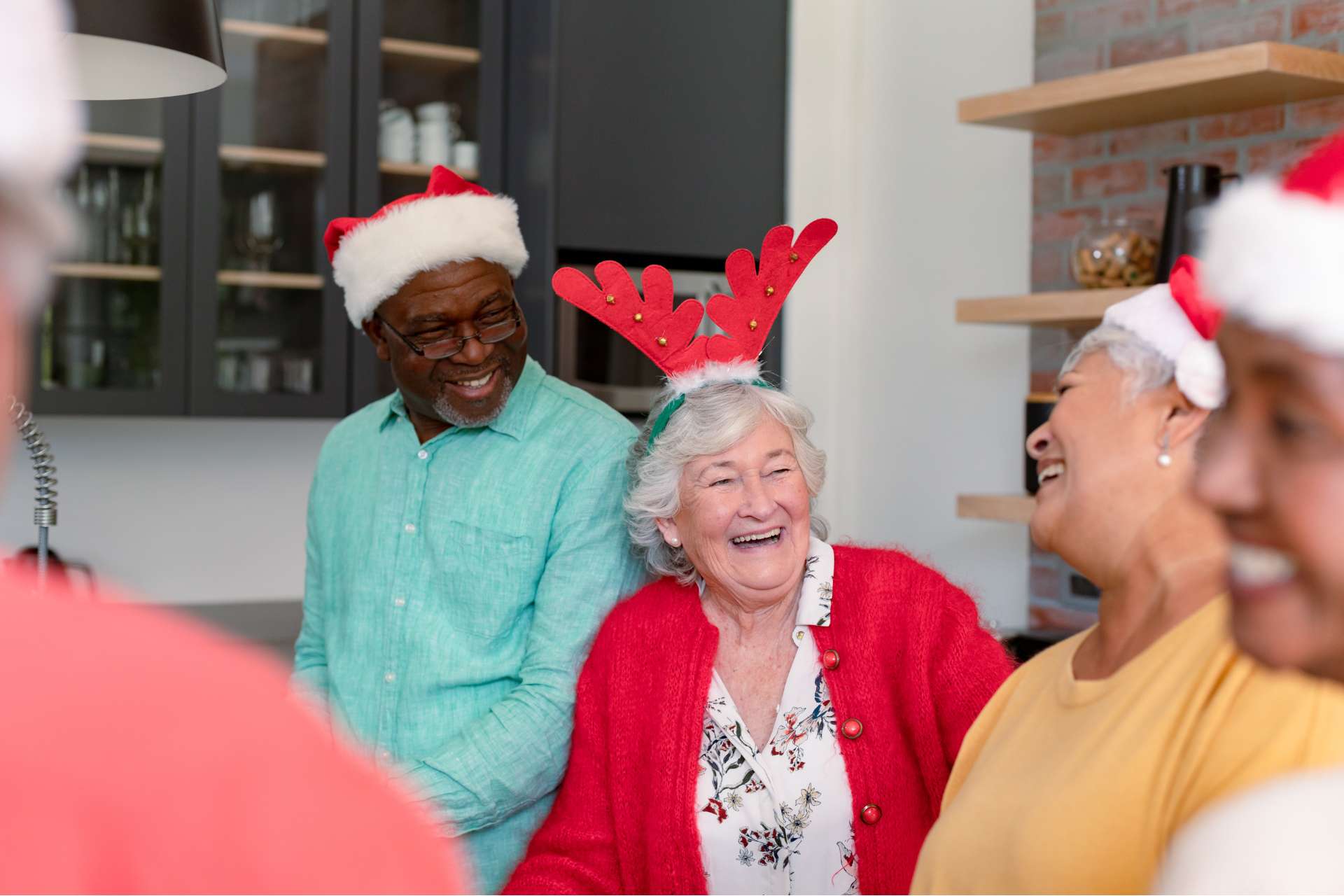 A group of seniors wearing holiday themed headwear